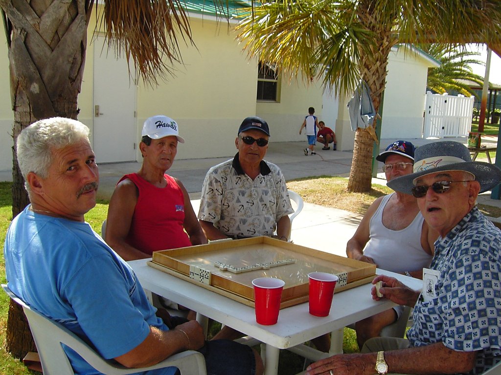 L to R: Orlando Velez, Jimmy Rivera, Adolfo Irrizary, Jorge Rivera and Juan Piñeiro playing dominoes